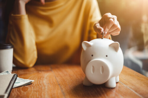 A person accumulating non-dues revenue and storing that money in a piggy bank.