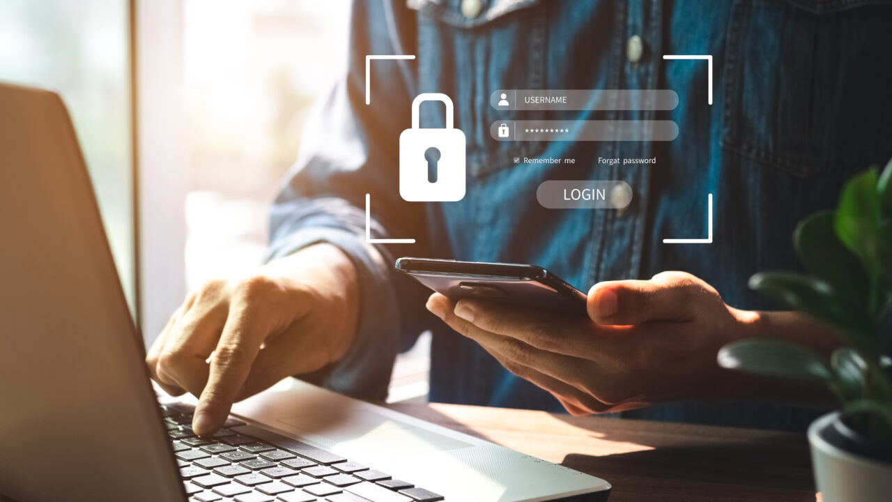 cyber security image of someone logging into their computer with a secure password graphic