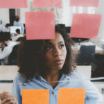 
                            woman looking at sticky notes that would be replaced by membership software                            