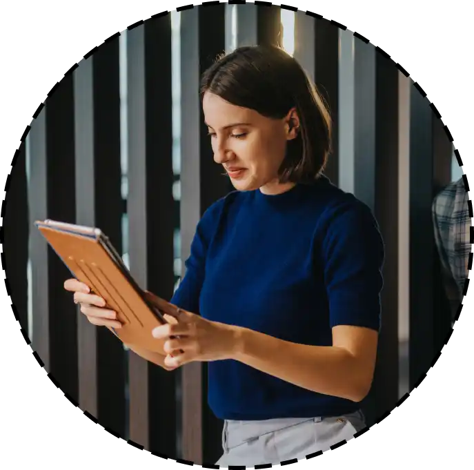 a woman holding a tablet computer at her office